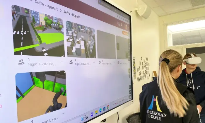 Elev som testar VR-glasögon med en skärm i förgrunden.