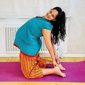 Women in yoga a position while pregnent 